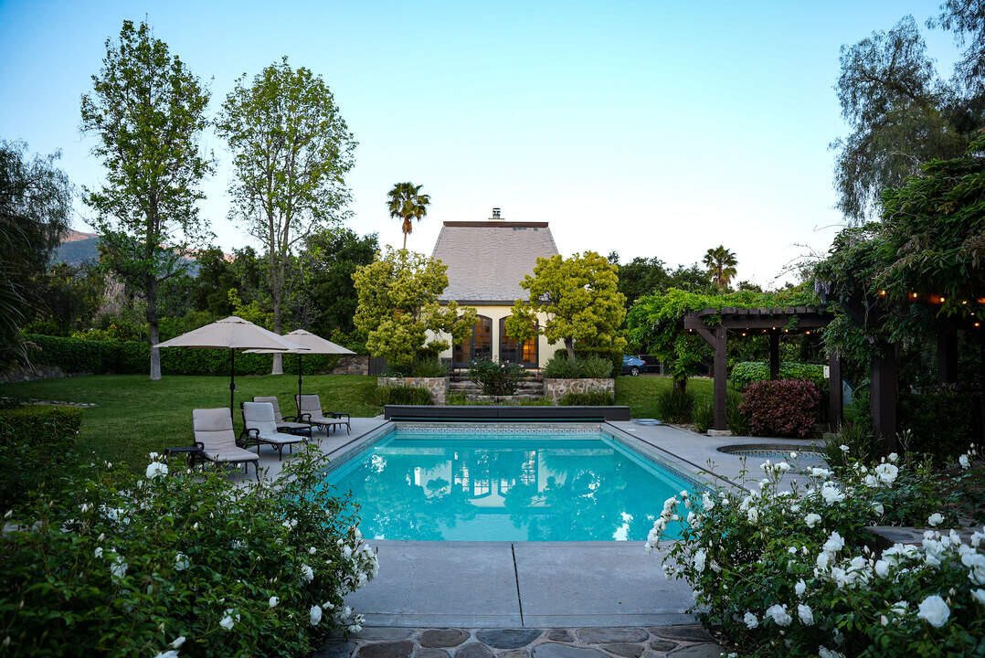 Outdoor pool with flowers and greenery